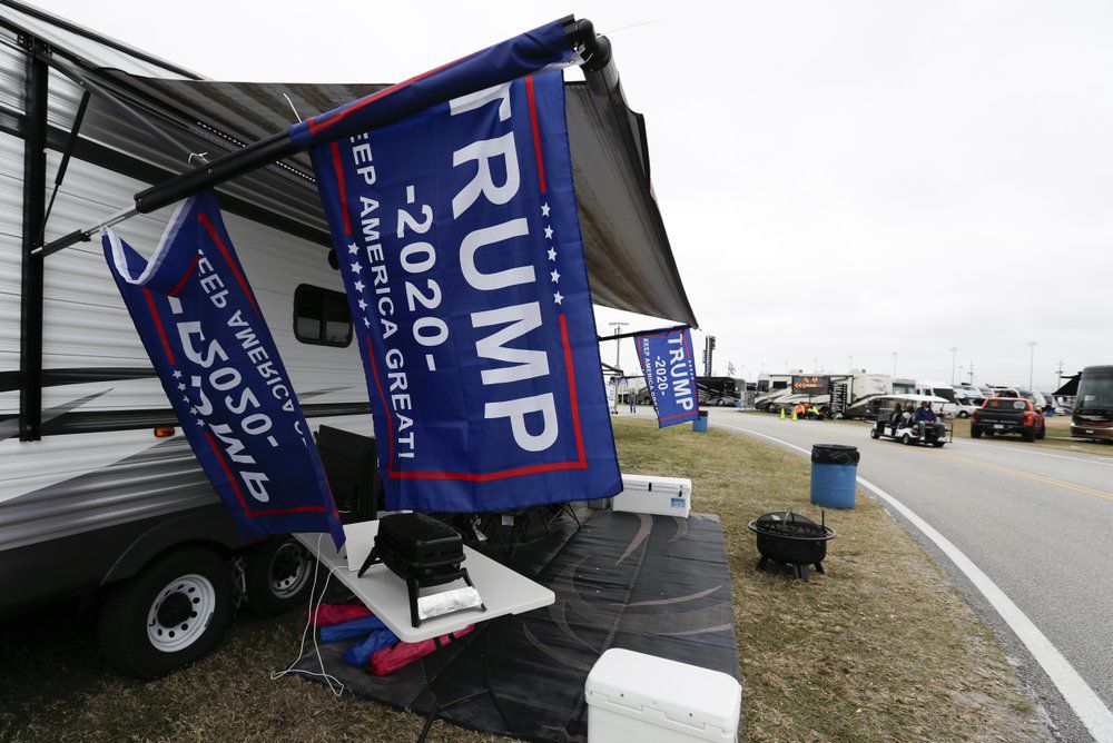 Flags supporting President Donald Trump fly in the infield days before his appearance at the NASCAR Daytona 500